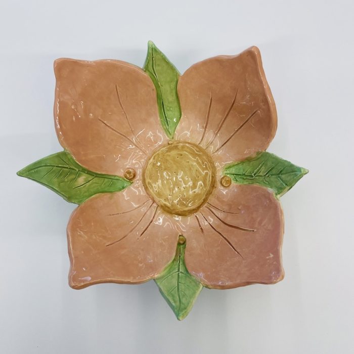 Orange and green pottery flower.