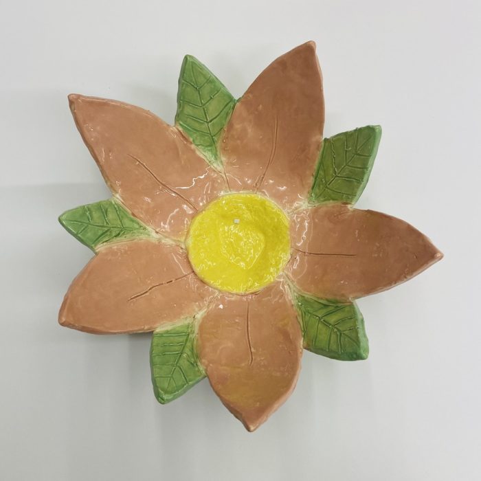 Orange and green pottery flower.