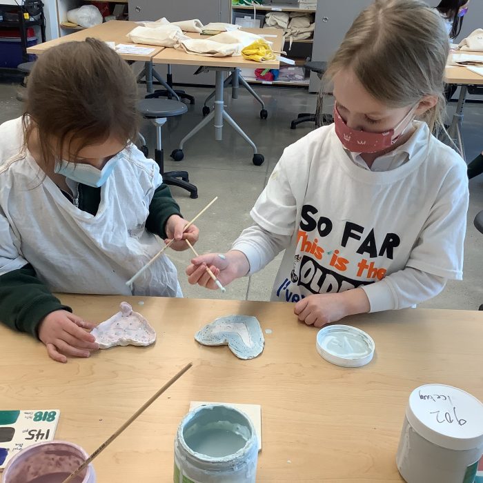 Grade 1 students making clay hearts.