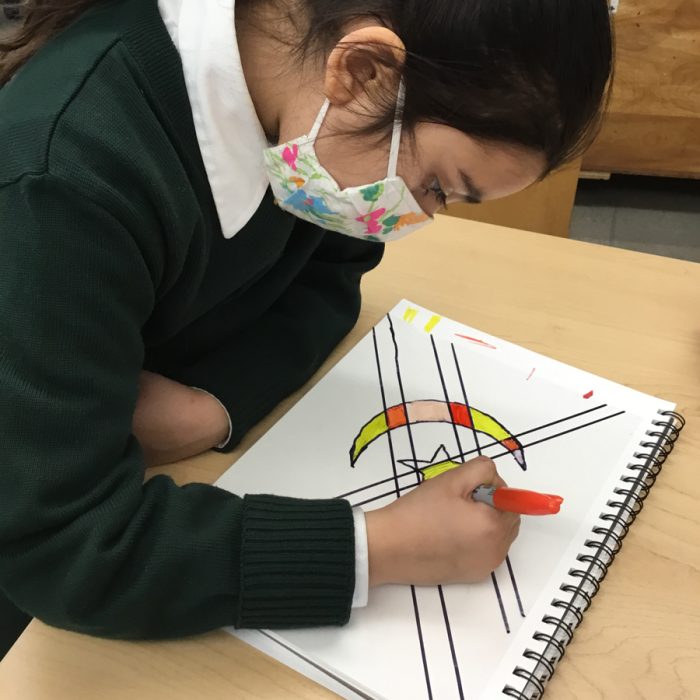 Student drawing a stain glass template.