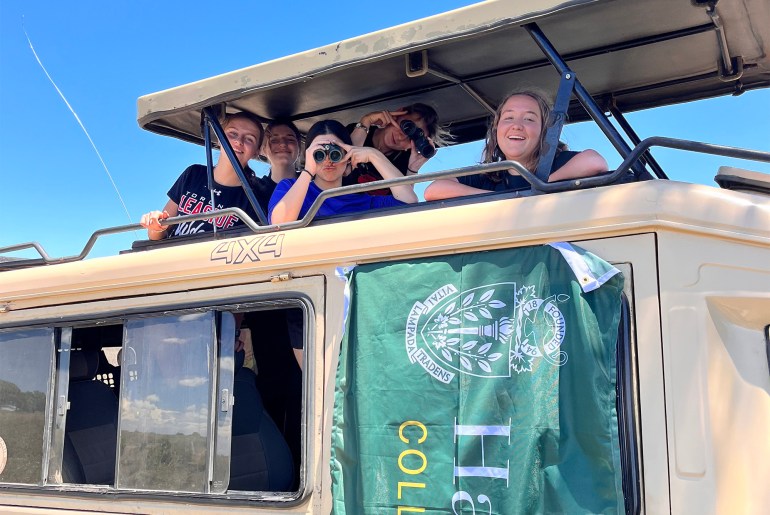 Students on safari in a jeep in Africa.