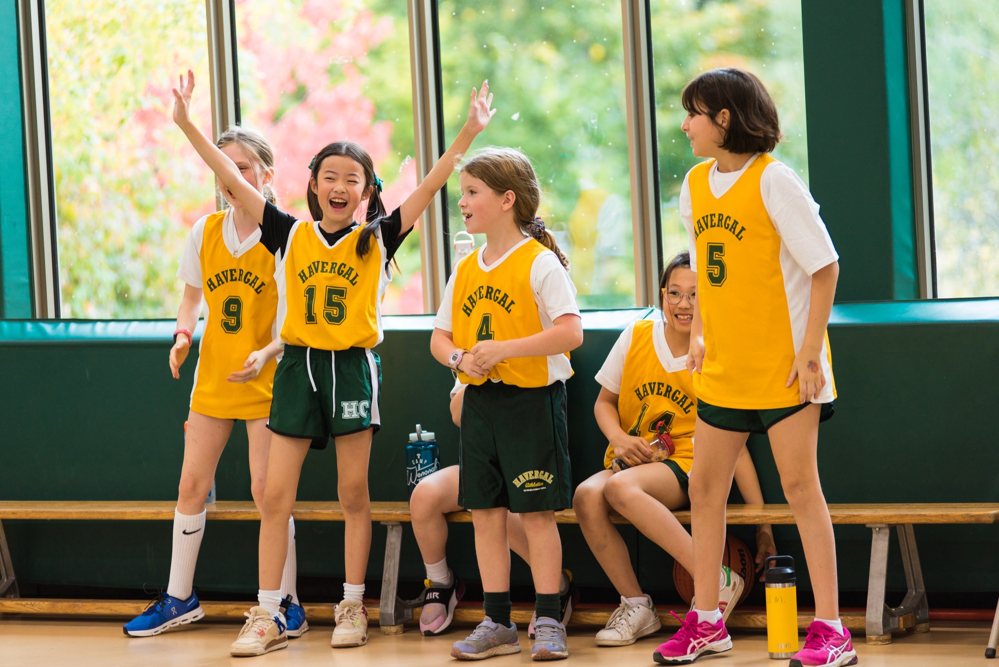 Junior School student cheering at a basketball game.