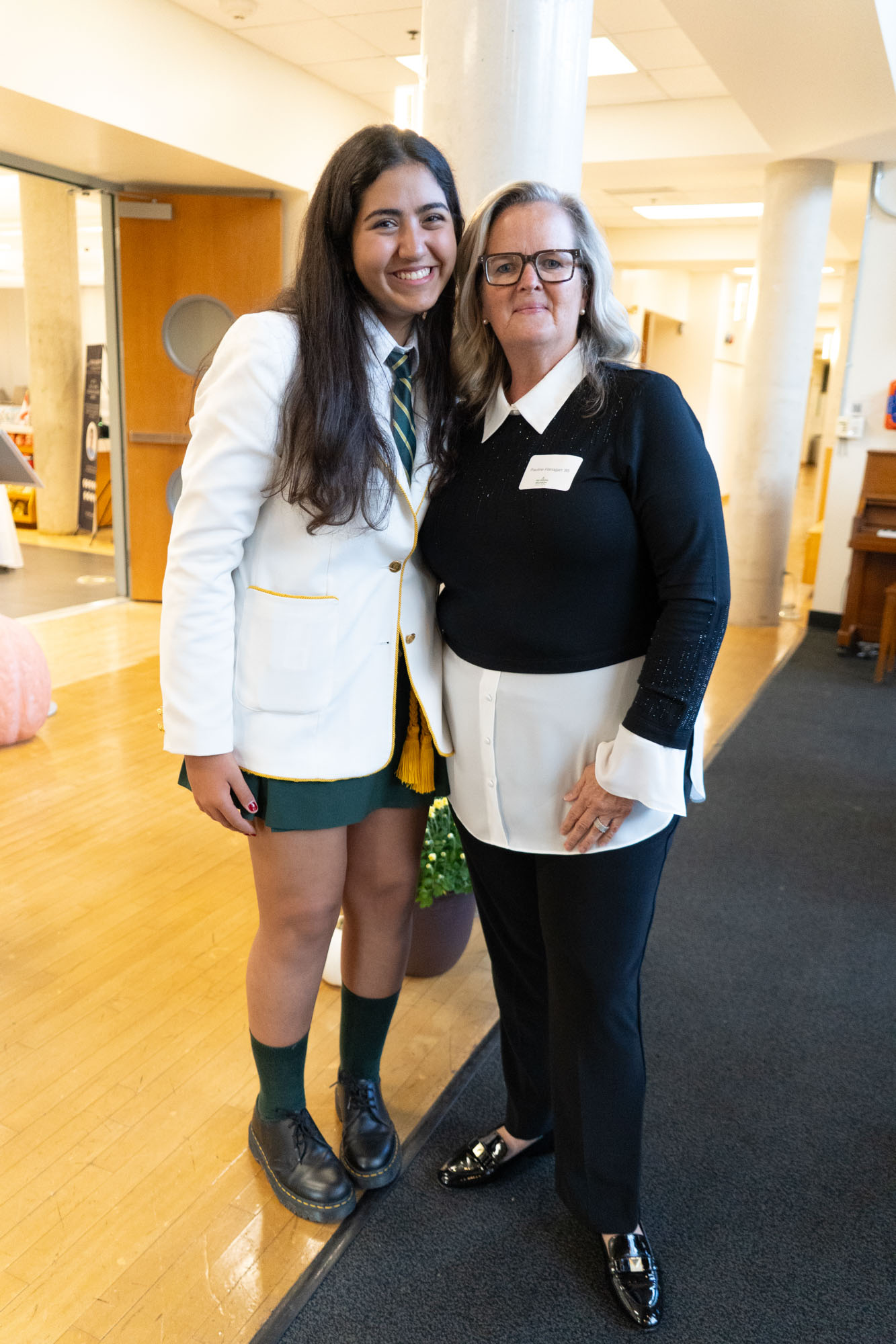 A student standing next to an Old Girl.